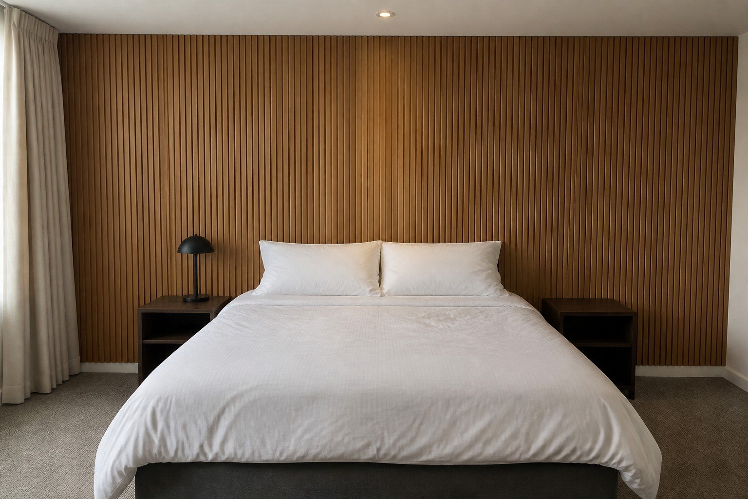 Tambour panel headboard wall in a hotel guest room
